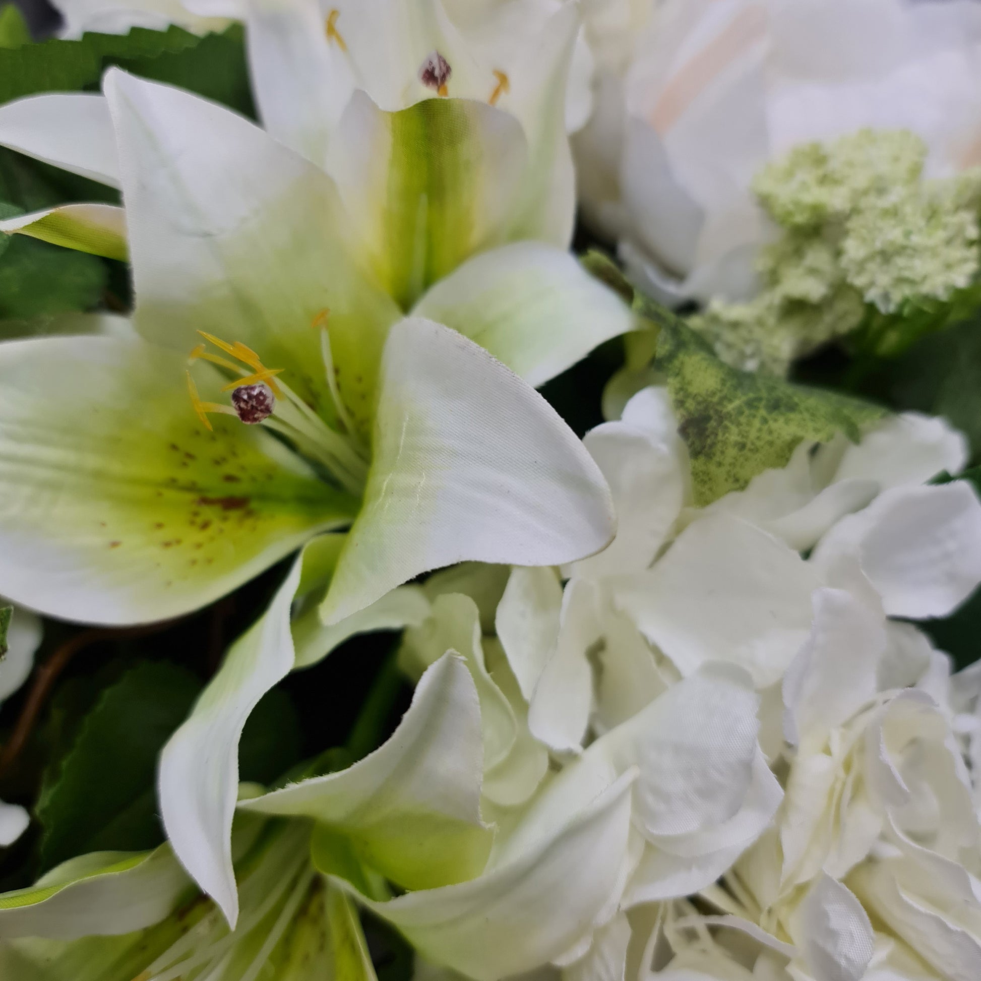 artificial white hydrangeas and lilies, coffee table floral arrangement in olive green ceramic vase french country