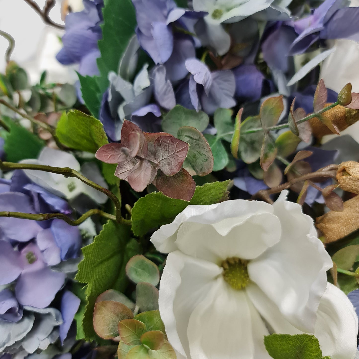 artificial blue and purple hydrangeas white magnolia floral arrangement