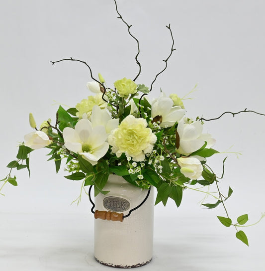 artificial white magnolia white ranunuculus floral arrnangement in aged antique cream milk churn