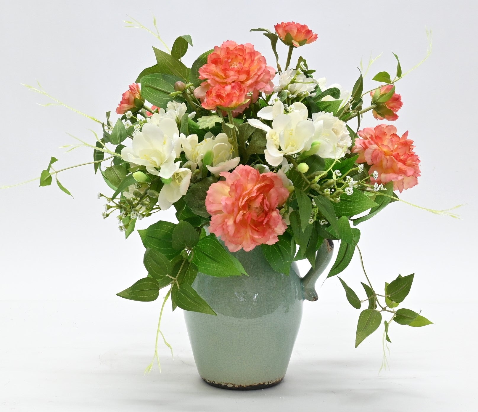 silk flower arrangement coffee table size mix of ranunculus white freesia and greenery in duckegg rustic aged ceramic jug