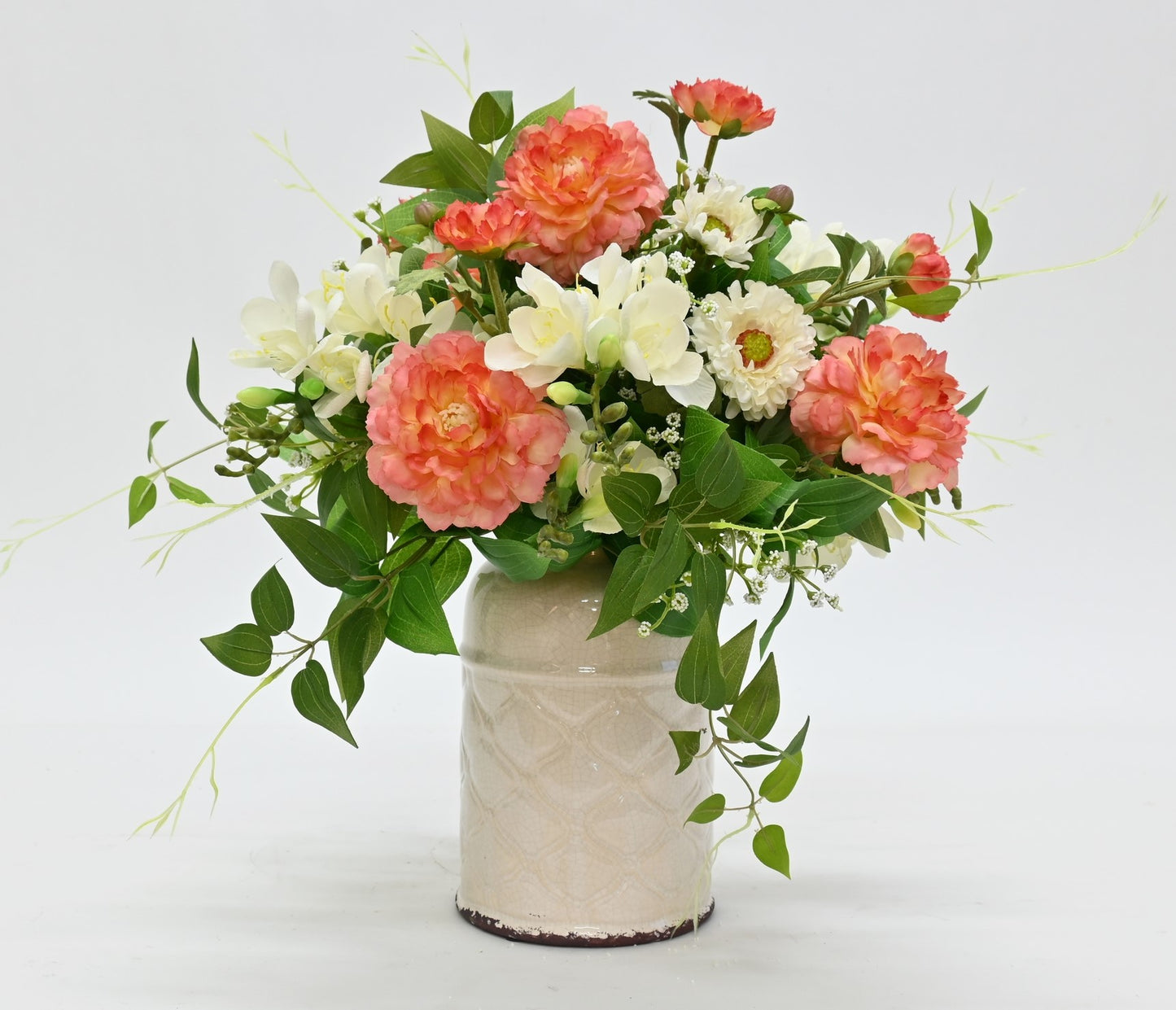 faux floral arrangement for coffee table or hall table mix of peach ranunculus white freesia white daisy set in white aged ceramic vase